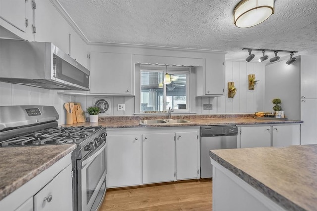 31 Darling St, Acushnet, MA 02743 - kitchen featuring a textured ceiling, appliances with stainless steel finishes, a sink, white cabinets, and light wood-style floors
