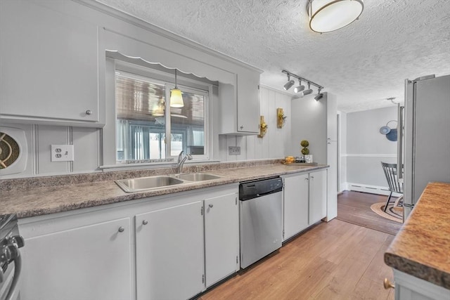 31 Darling St, Acushnet, MA 02743 - kitchen with a sink, a textured ceiling, stainless steel appliances, and light wood-style flooring