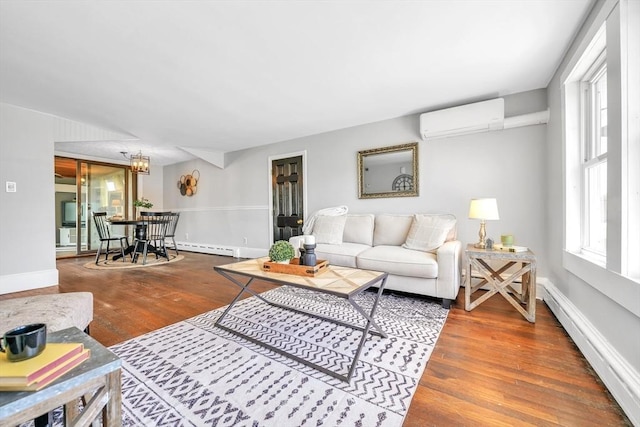 31 Darling St, Acushnet, MA 02743 - living room with wood finished floors, a baseboard radiator, baseboards, and a wall unit AC