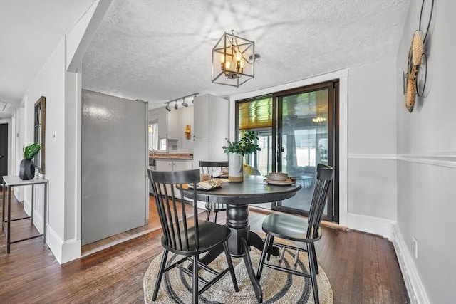 31 Darling St, Acushnet, MA 02743 - dining area featuring baseboards, a textured ceiling, a notable chandelier, and wood finished floors