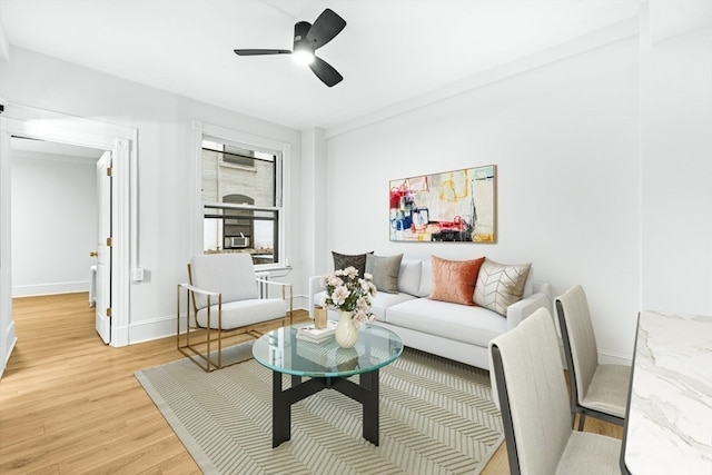 living room with wood-type flooring and ceiling fan