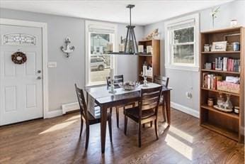 dining room with dark wood finished floors and baseboards