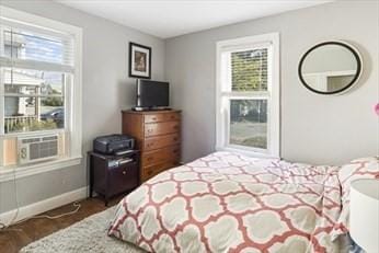 bedroom with baseboards and dark wood-style flooring