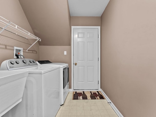 laundry room featuring laundry area, baseboards, a sink, and washing machine and clothes dryer