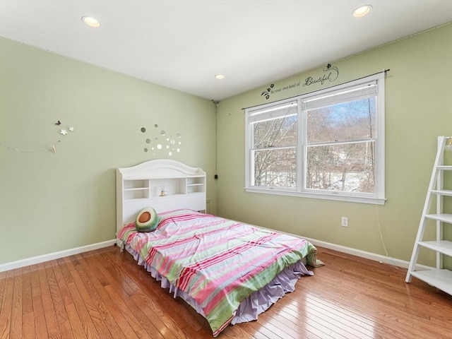 bedroom with hardwood / wood-style floors, recessed lighting, and baseboards