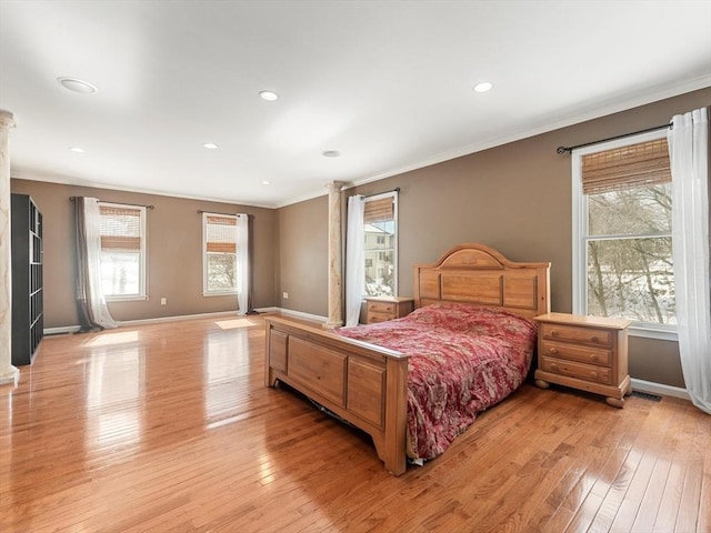 bedroom with ornamental molding, recessed lighting, baseboards, and light wood finished floors