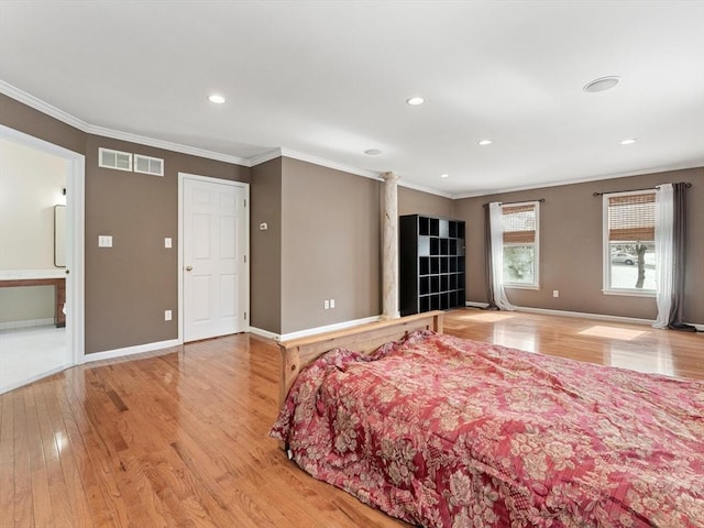 bedroom with baseboards, crown molding, and wood finished floors