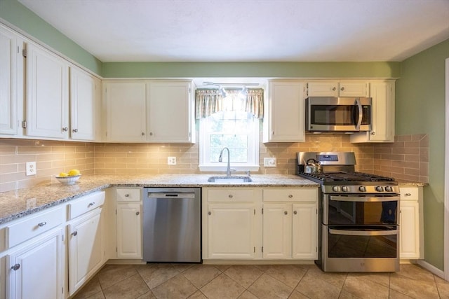 165 Roundtop Rd, Marlborough, MA 01752 - kitchen with stainless steel appliances, a sink, backsplash, light stone countertops, and white cabinets
