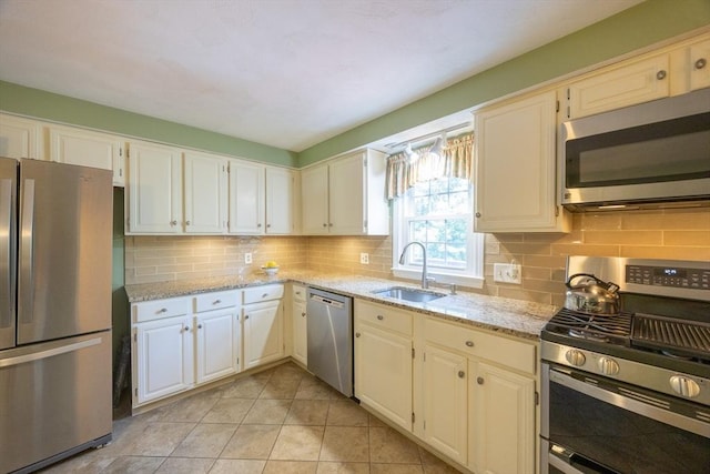 165 Roundtop Rd, Marlborough, MA 01752 - kitchen with stainless steel appliances, a sink, decorative backsplash, and light stone counters