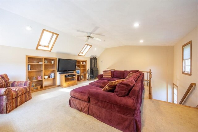 165 Roundtop Rd, Marlborough, MA 01752 - living area with light carpet, a skylight, lofted ceiling, built in shelves, and a ceiling fan