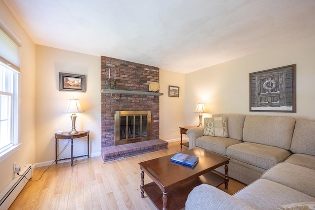 165 Roundtop Rd, Marlborough, MA 01752 - living area with a baseboard radiator, wood finished floors, plenty of natural light, and baseboards