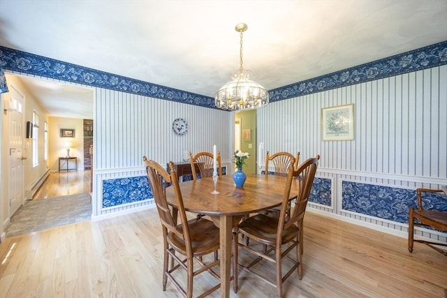 165 Roundtop Rd, Marlborough, MA 01752 - dining space with wallpapered walls, a baseboard heating unit, light wood finished floors, a chandelier, and baseboards