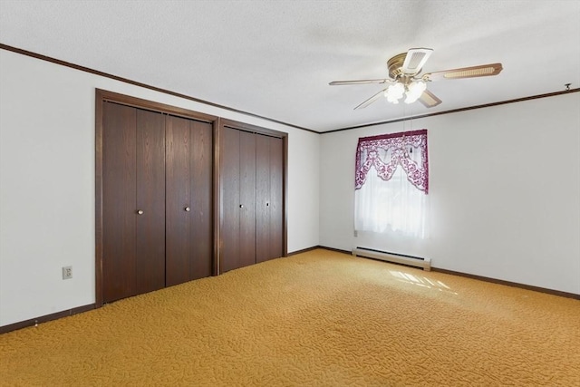 58 Daniel Shays Hwy, Pelham, MA 01007 - unfurnished bedroom with two closets, baseboards, ornamental molding, and baseboard heating