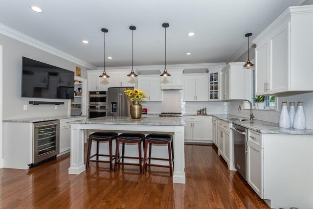 1 Clearview Dr, Franklin, MA 02038 - kitchen featuring beverage cooler, stainless steel appliances, white cabinets, tasteful backsplash, and light stone counters