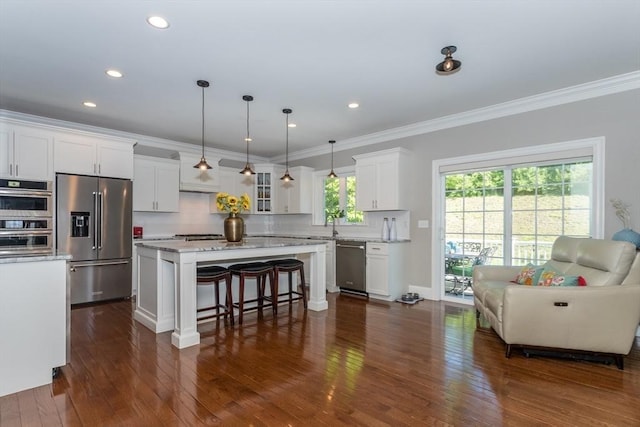 1 Clearview Dr, Franklin, MA 02038 - kitchen with appliances with stainless steel finishes, a breakfast bar area, white cabinetry, a center island, and dark wood finished floors