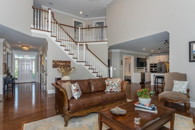 1 Clearview Dr, Franklin, MA 02038 - living area featuring a high ceiling, stairway, wood finished floors, baseboards, and crown molding