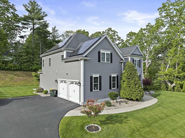 1 Clearview Dr, Franklin, MA 02038 - view of property exterior with driveway, roof mounted solar panels, a yard, and an attached garage