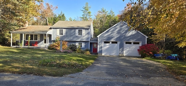 view of front of property featuring a garage, a front yard, and covered porch