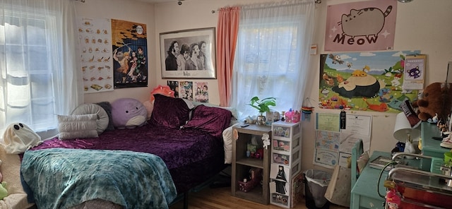 bedroom with wood-type flooring and multiple windows