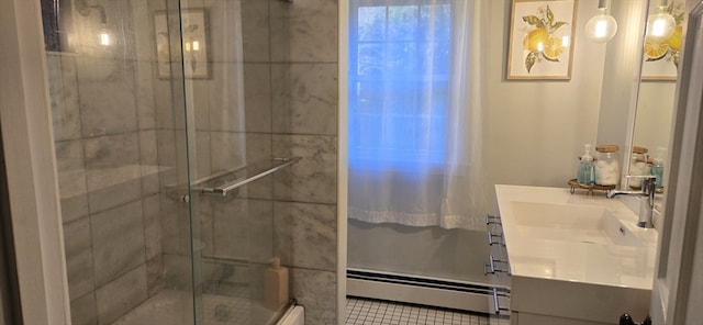 bathroom featuring baseboard heating, a shower with shower door, and vanity