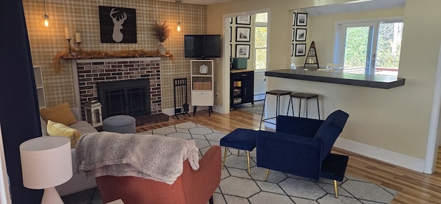 living room featuring hardwood / wood-style floors and a brick fireplace