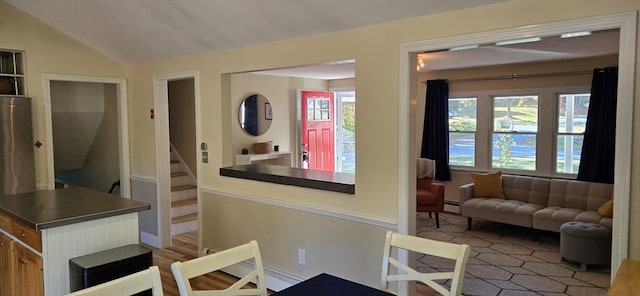 interior space with a baseboard radiator and lofted ceiling