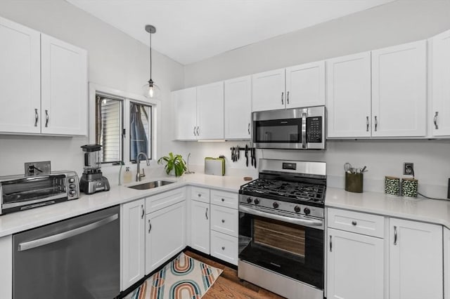 381 Bunker Hill St Unit 1, Boston, MA 02129 - kitchen with appliances with stainless steel finishes, white cabinetry, and light countertops