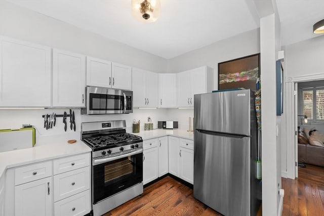 381 Bunker Hill St Unit 1, Boston, MA 02129 - kitchen with appliances with stainless steel finishes, dark wood-type flooring, light countertops, and white cabinets