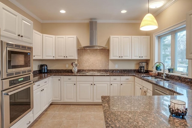 kitchen featuring white cabinetry, appliances with stainless steel finishes, sink, and wall chimney range hood