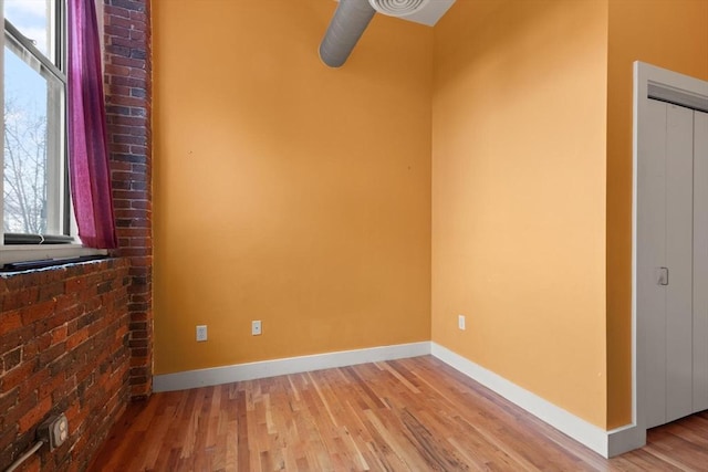 unfurnished room featuring light wood-style flooring and baseboards