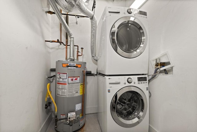 laundry room with stacked washer / drying machine, laundry area, and water heater