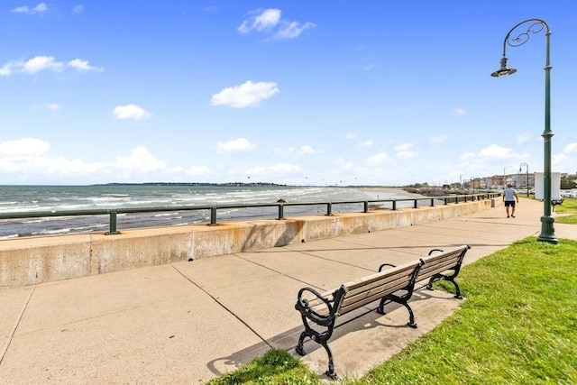 view of community with a water view and a beach view