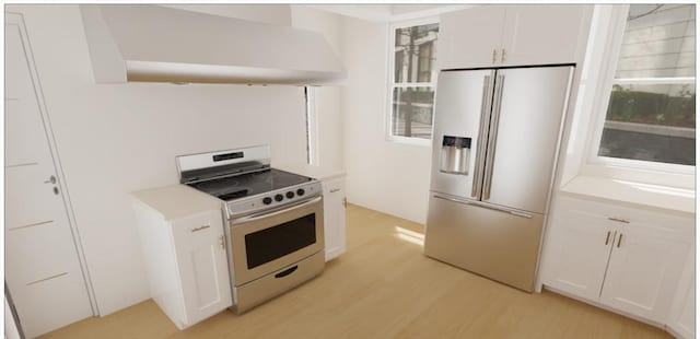 kitchen featuring white cabinets, wall chimney exhaust hood, light wood-style flooring, stainless steel appliances, and light countertops