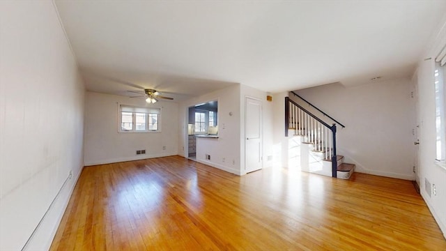 unfurnished living room featuring hardwood / wood-style floors and ceiling fan