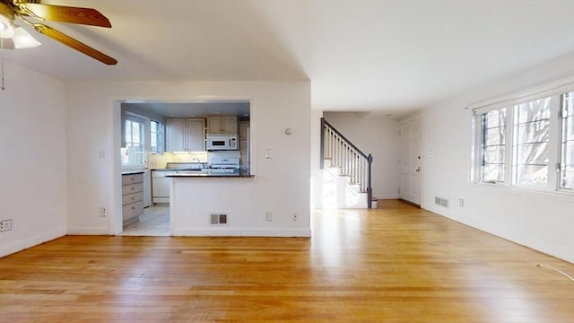 unfurnished living room with light hardwood / wood-style floors and ceiling fan