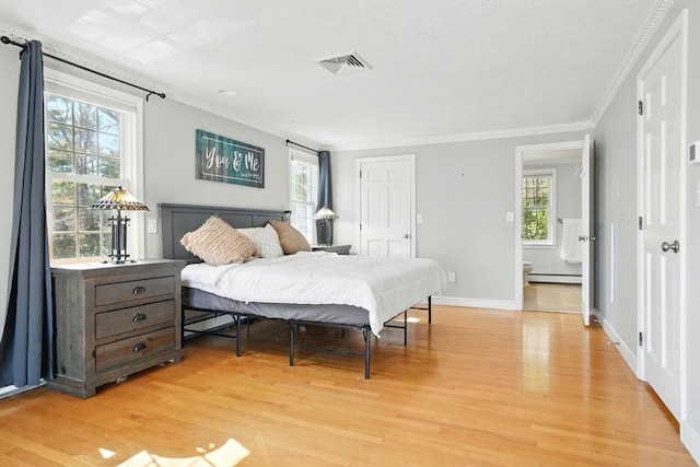 bedroom with a baseboard heating unit, light wood-style flooring, baseboards, visible vents, and crown molding