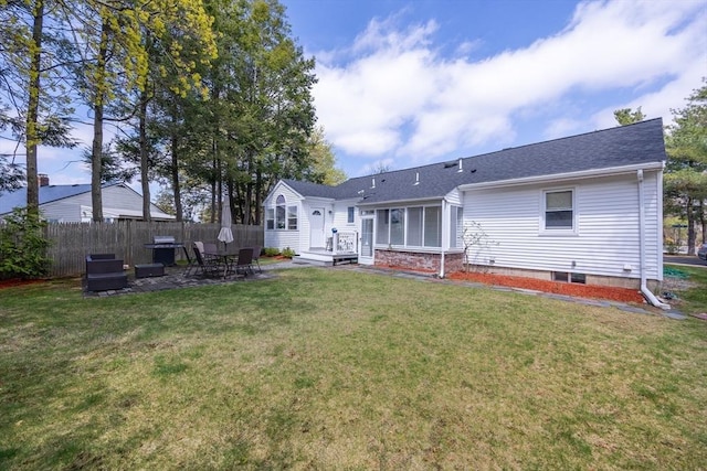 back of house with fence, a patio area, a yard, and a shingled roof