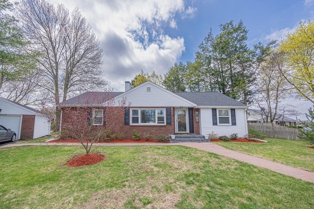 ranch-style home featuring a chimney, an outdoor structure, brick siding, fence, and a front lawn