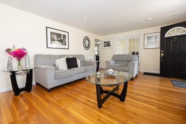 living room with light wood finished floors and baseboards