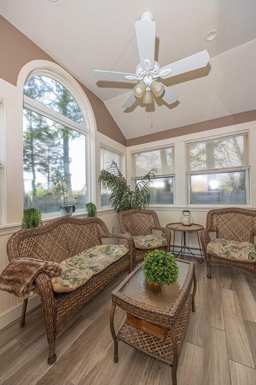 sunroom with vaulted ceiling and wood finished floors