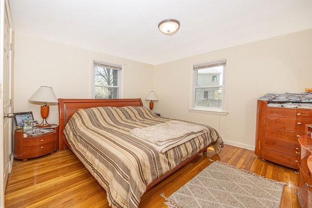 bedroom featuring baseboards and light wood-type flooring