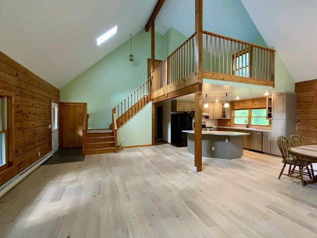 186 Hoosac Rd, Conway, MA 01341 - living area featuring high vaulted ceiling, wooden walls, light wood-style floors, baseboard heating, and stairs