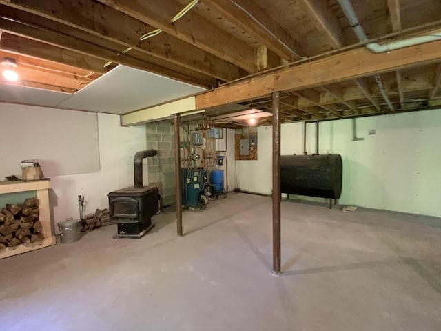 186 Hoosac Rd, Conway, MA 01341 - unfinished below grade area with heating fuel, a wood stove, a heating unit, a water pressure tank, and electric panel
