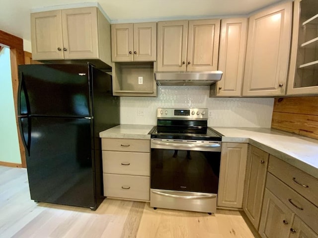 186 Hoosac Rd, Conway, MA 01341 - kitchen featuring stainless steel electric range oven, under cabinet range hood, freestanding refrigerator, light countertops, and light wood finished floors