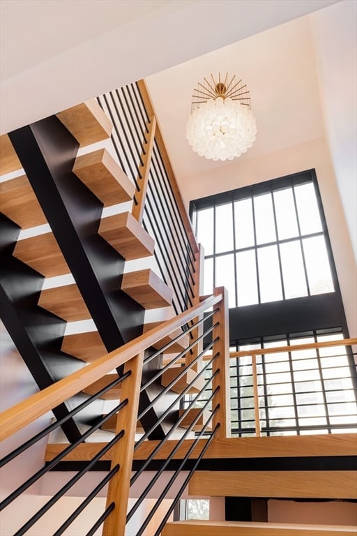 staircase featuring a chandelier