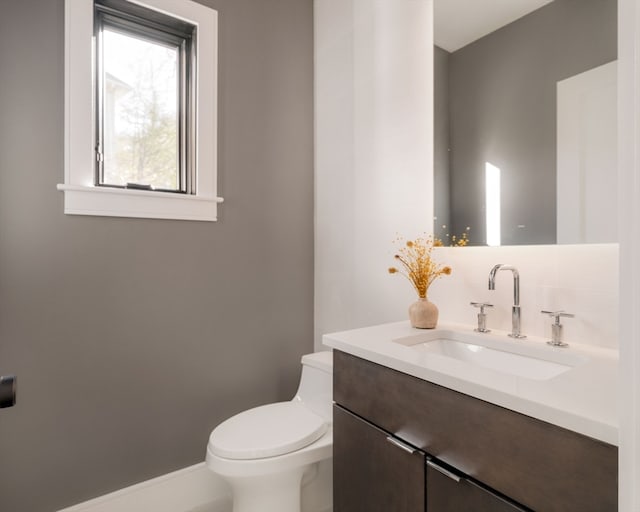 bathroom with toilet and vanity