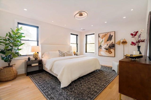 bedroom featuring multiple windows and light wood-type flooring