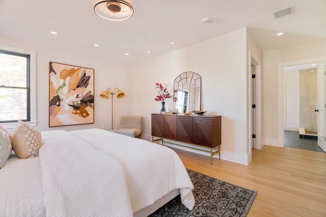 bedroom with hardwood / wood-style floors