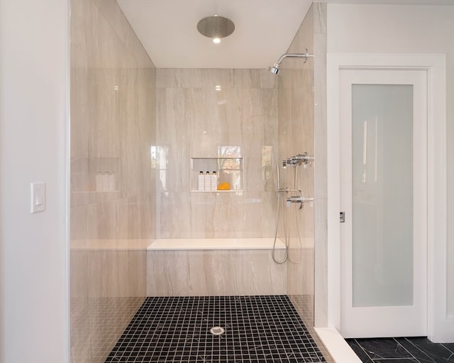 bathroom with a tile shower