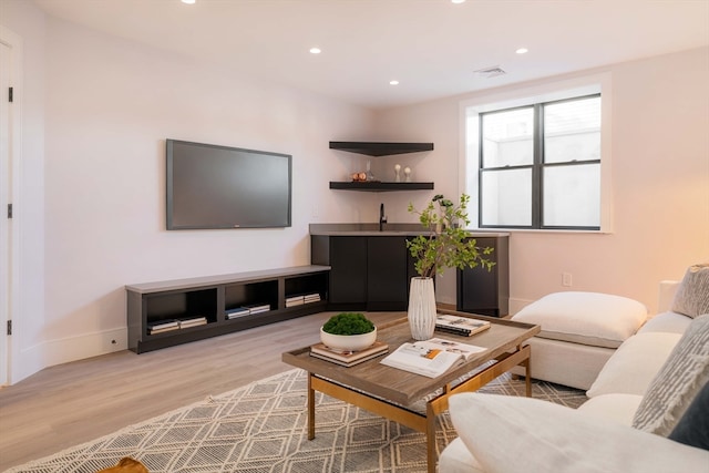 living room with light hardwood / wood-style flooring